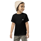 Toddler in a beanie wearing a black Apo (Grandchild) toddler t-shirt with white embroidered name on the left chest