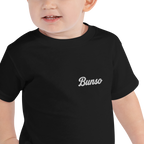 Toddler wearing a black Bunso (Youngest) toddler t-shirt with white embroidered name on the left chest, close-up