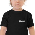 Toddler wearing a black Bunso (Youngest) toddler t-shirt, close-up of the white embroidered name on the left chest