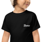 Smiling toddler in a black Bunso (Youngest) toddler t-shirt with white embroidered name on the left chest